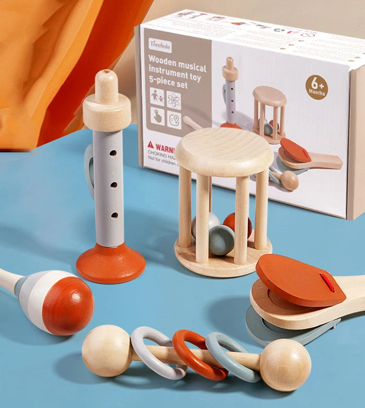 Wooden music instrument toy set with packaging on a blue surface