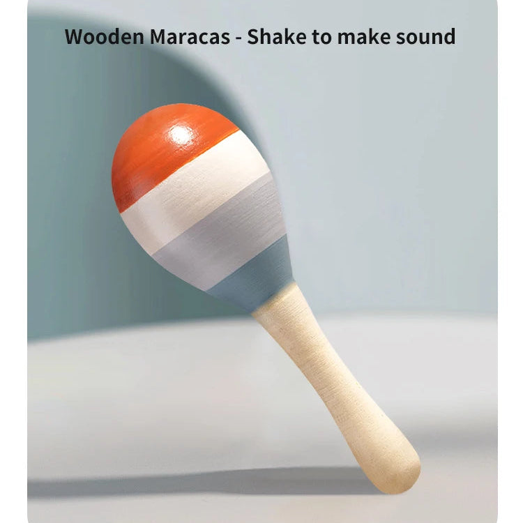 Wooden maracas with red and white striped shell on a gray background