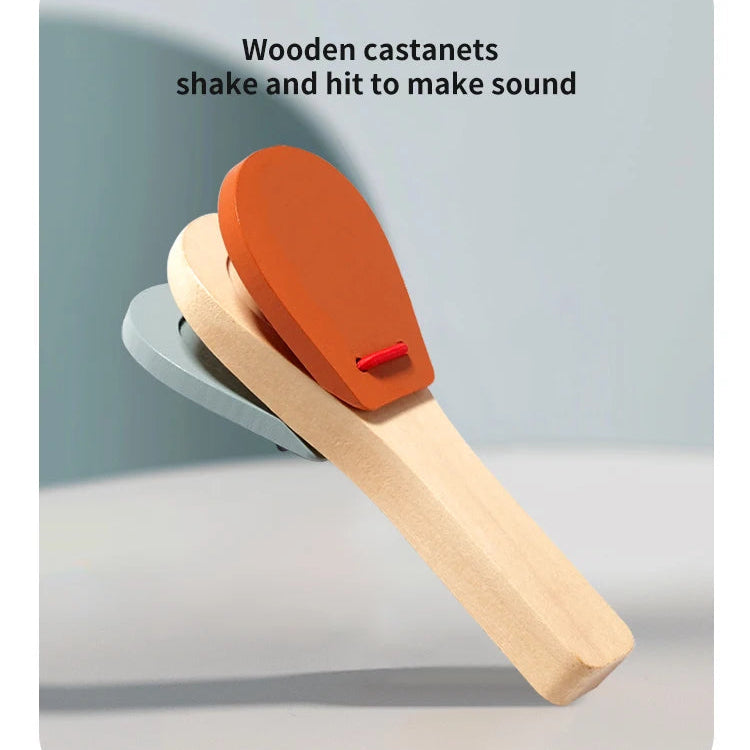 Wooden castanets with an orange top on a light gray background