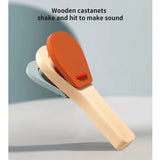 Wooden castanets with an orange top on a light gray background
